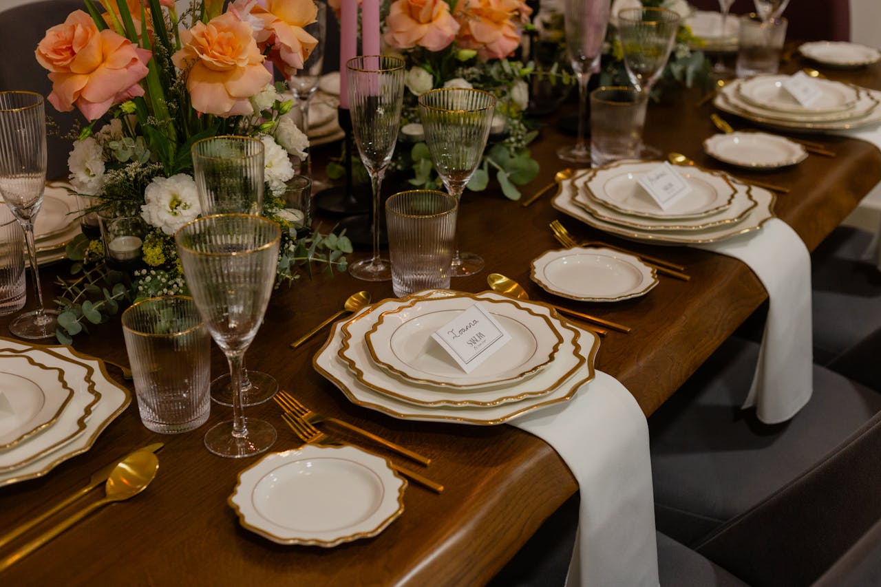 services-03 Luxurious table setting with floral decor, glassware, and gold accents at a wedding reception.