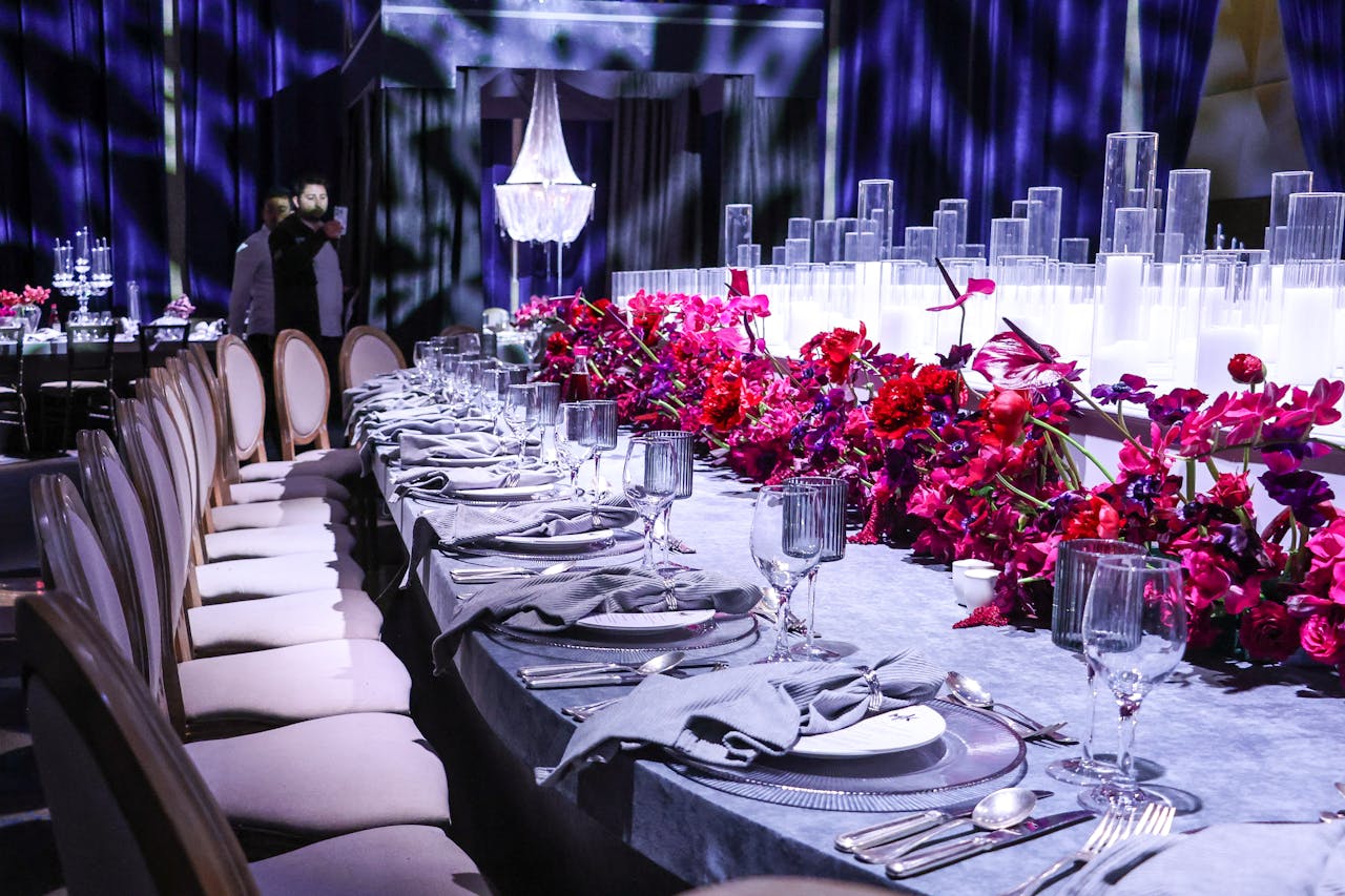 services-01 A luxurious table setting with vibrant floral decorations and elegant tableware, perfect for upscale events.